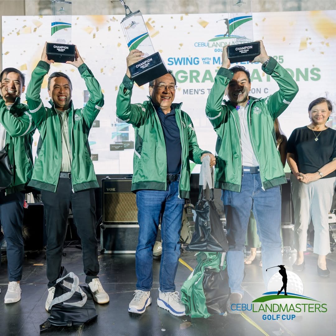 Team champions holding their trophies overhead on stage